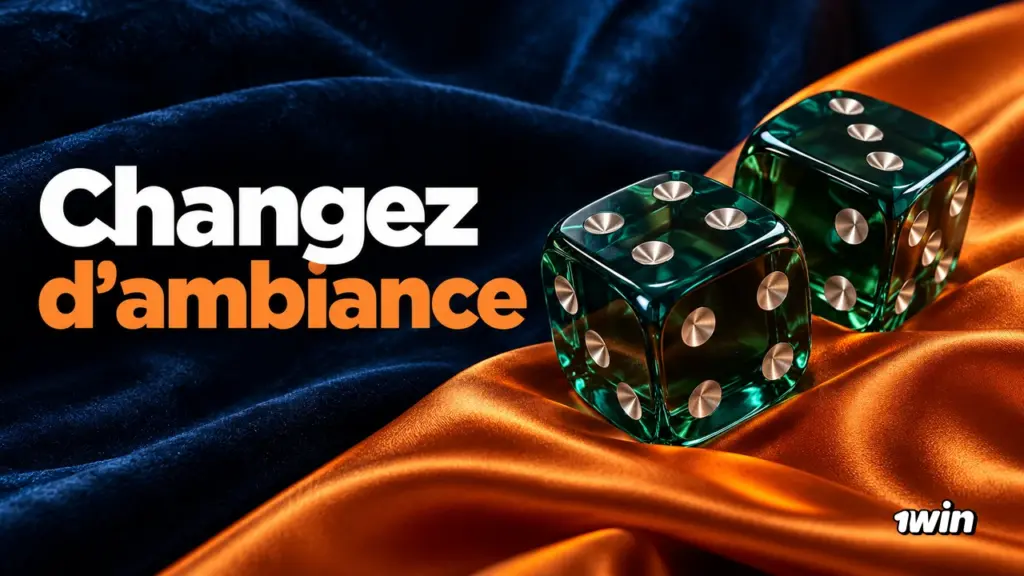 Deux dés verts translucides sur des tissus bleu et orange